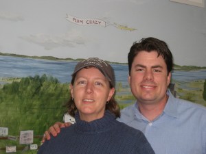 Manager Trish Cram and owner Kurt Littlefield in front of mural inside Plum Crazy.