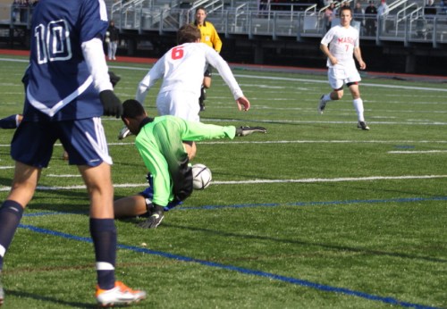 C - MHS goalie Bryan Peguero sticks out leg on Chip Sherman as ref get clear look