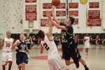 masa A8 Kyle Sangster (17 points) shoots over Billy Muse