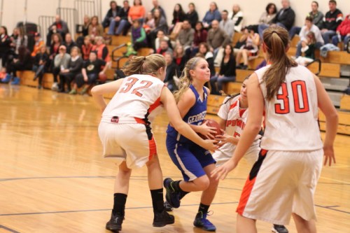 The Ipswich defense surrounds Georgetown senior Kylie Troy