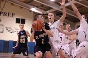 Tommy DeVeau (14 points) closely guarded by Mike Bisson