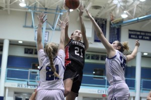 Ally Fenner shoots over Taylor Herd and Ashlee Ruzicka