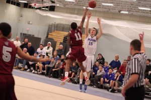 Nick Bates (14 points) takes a three over Anthony Silfa (11)