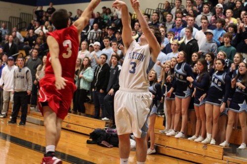 Paul Dacy of Triton shoots the game-winner over Brian Reardon in front of the Viking student section.