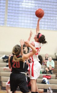 Claudia Marsh (nine points) shoots over McKenzie Mello