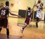 Kevin Scarlett (12 points) shoots over Kam Nobles