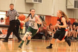 Kelsi McNamara (13 points) dribbles and Brigid OFlynn chases