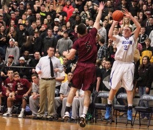 Vinny Clifford (14 points) fires a three over Nathan Frongillo