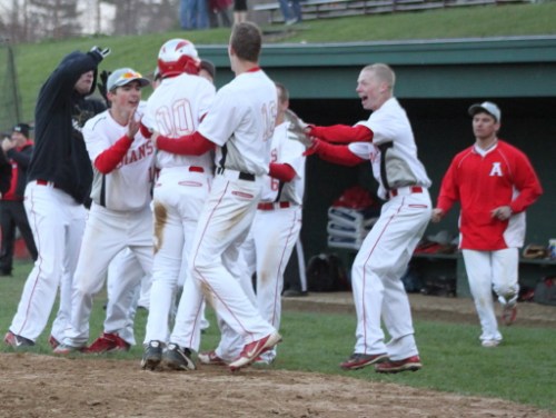 Adam Ivancic (00) is mobbed after scoring the winning run