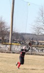 Centerfielder Morgan Coakley chases a flyball in the strong wind at Cashman Park