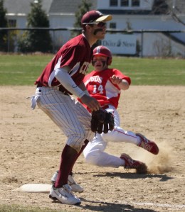 Shane Ripley starts his slide into third as Colton Fontaine waits for a throw