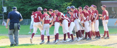 Connor Wile (#3) is met at home by his teammates in the fifth inning after a long home run.