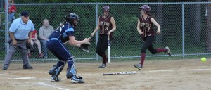 Catcher Julia Hartman waits for the throw as Kendra Dow tries to score.