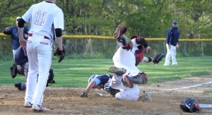 Nick Desrocher sends Amesbury catcher Mac Short flying