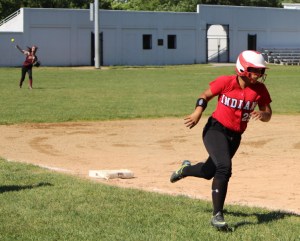 Ashley Valme heads for home as Kendra Dow throws from the outfield