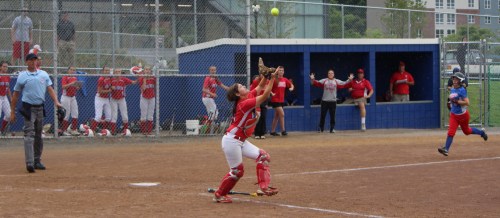 Catcher Krista Toscano eyes the final out as Meaghan McLaughlin runs for the plate