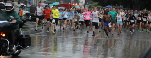 The runners slosh off in the Harrison 5K.  Tim Even, in the blue shorts, gets a fast start.