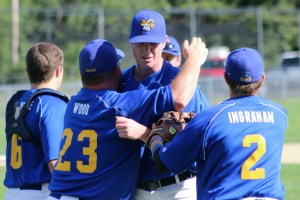 Rams coach Jeff Wood congratulates closer Joe Martin after the final out