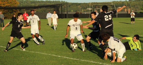 Bowdoin GK Jake Muscato (#23) is down and out as Nico Kaiafas (#9) has the ball at his feet