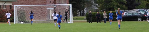 Orie Inirio (far right) sends a shot over Kennebunk goalie Kyra Schwartzman to tie the score.