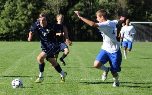 Mitchell Hickey (2 goals) tries to get past Brandan George