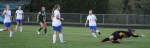 Senior Ella Millard drills a shot past Isabel Scribner