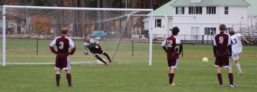 Freeport goalie Brendan Qualls guesses left and Gabe Perry shoots the penalty kick right.