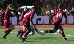 Jenna Soucy, in the midst of four Rams, fires the third goal