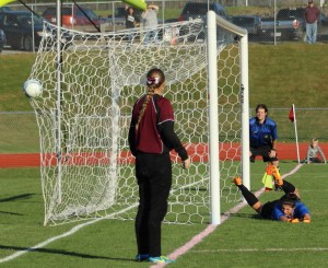 Liz Mycock watches the shot of Lauren Shoemaker go in the net to win the game for Windham