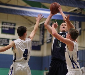 Erik Fyrer (13 points) gets off a shot in the lane