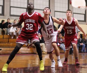 Michael Osarenren (32), Jon Siu (33), and Patrick Davis (15) look for a rebound