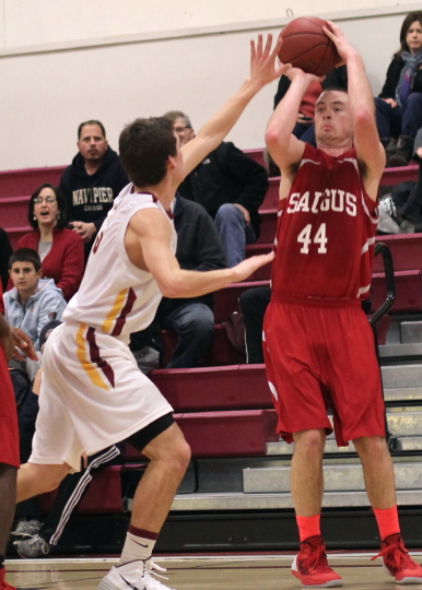 Joe Bertrand (32 points) shoots a three over Drew Bourdeau