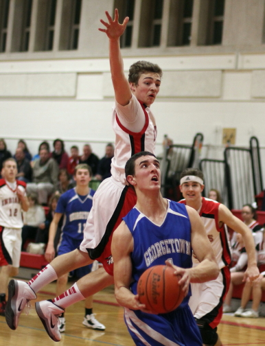 Pat Bjork (19 points) avoids leaping Ryan Foley