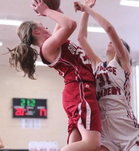 Courtney Cashman (17 points) tries to shoot over Gabrielle Reuter (16 points)