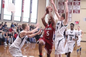 Kam Nobles (11 points) tries to go between Erik Fyrer and Griffin Beal