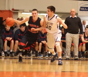 Tyler Nelson drives on Max Burt (16 points) as CC coach Rick Nault watches
