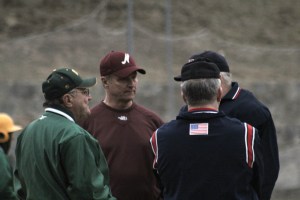Frank Carey, Steve Malenfant, and the umpires meet after the ninth inning