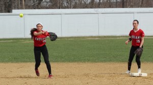 Maddie Napoli throws to first