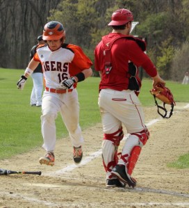 Chris Grady scores on a hit by Mike Savoie