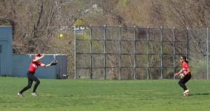 Centerfielder Meagan Aponas tracks a fly ball and rightfielder Alexi Boswell looks on