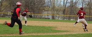 Travis Wile flips the ball to pitcher James Nutter covering first