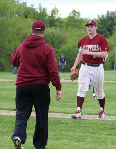 Coach Steve Malenfant congratulates reliever Will Cataldo