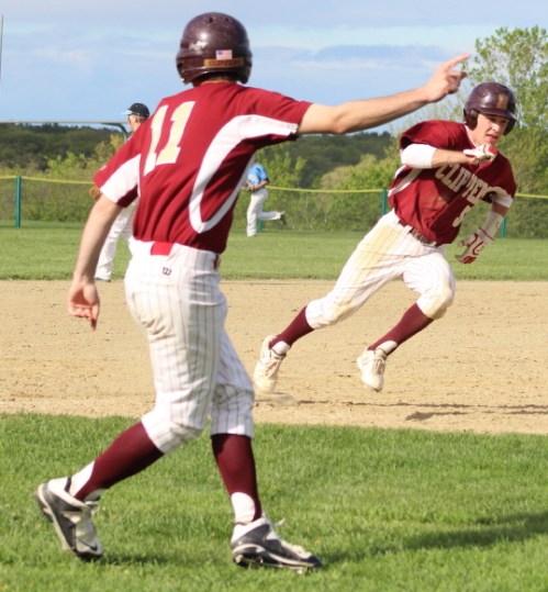Jeremy Grabowski (#11) points baserunner Caleb Stott to home