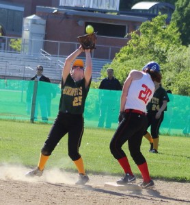 Tarah Reilly takes in a popup as baserunner Maddie Kelly ducks out of the way