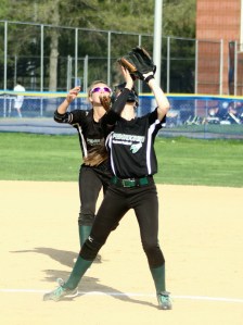 Pitcher Jenny Nelson eyes an infield popup with second baseman Sydney Snow behind her
