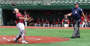 Jordan Pallazola flips his mask before making a catch