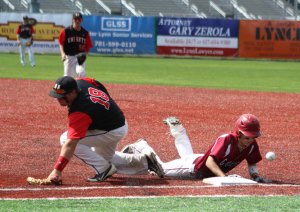Ball gets away from NA first baseman Collin Couillard as Eric Chalmers touches first