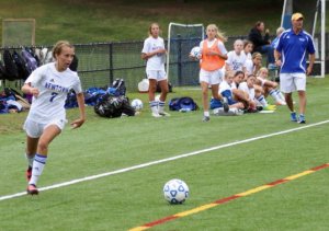 Hannah Booth looks to shoot as the Newtown bench watches