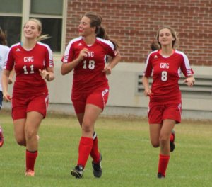 Izzy Detroy, Maria Valente, and Emma Woods celebrate a goal