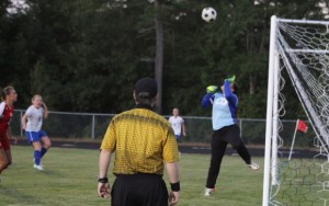 Patriots goalie Zoe Adams tips a shot over the net